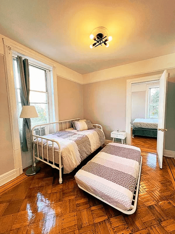 bedroom with moldings and wood floor