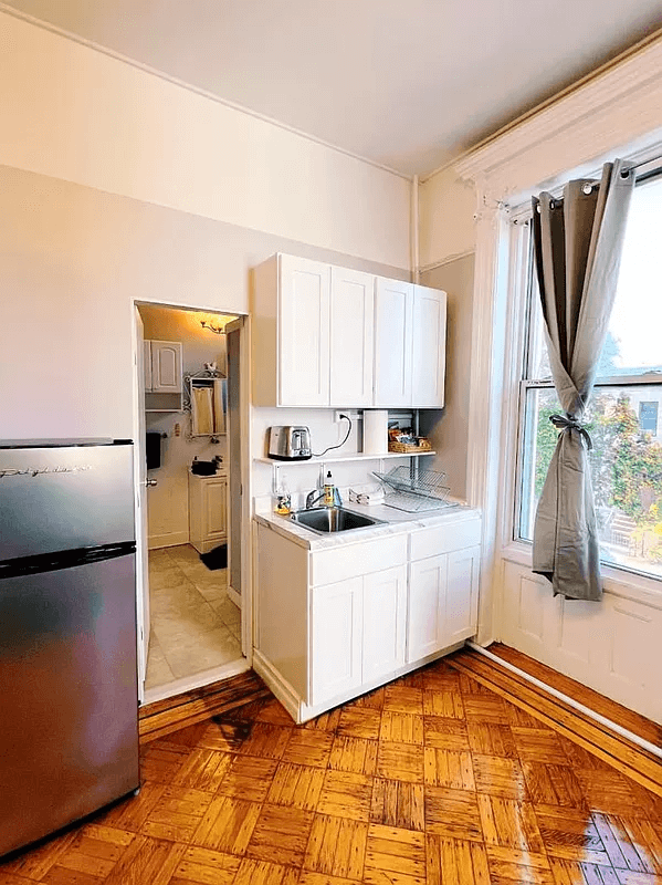 kitchen sink with view into bathroom