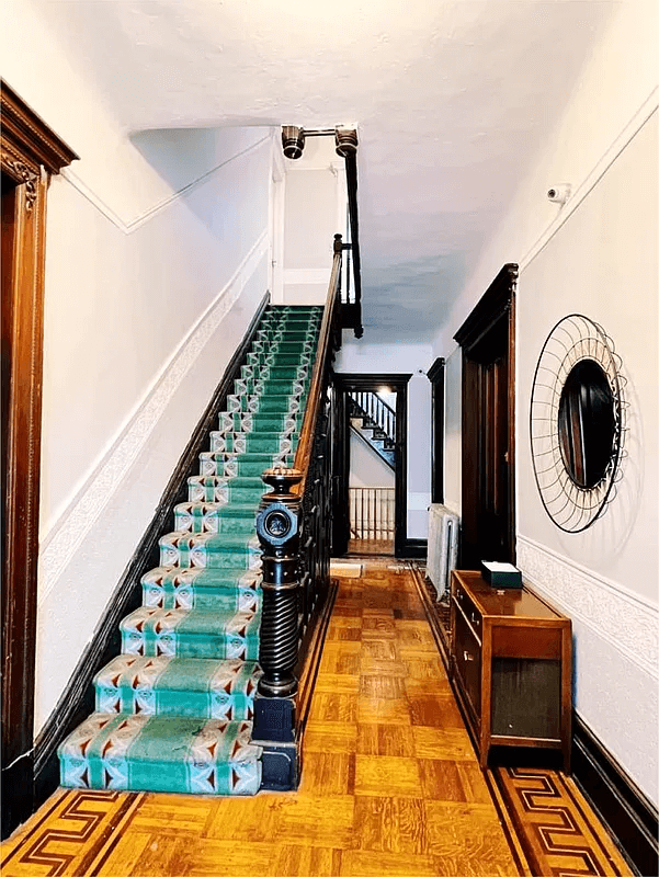 stair hall with green runner on stairs