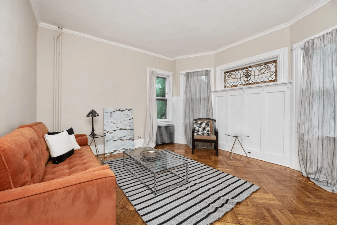 living room with one wall with wainscoting plus stained glass