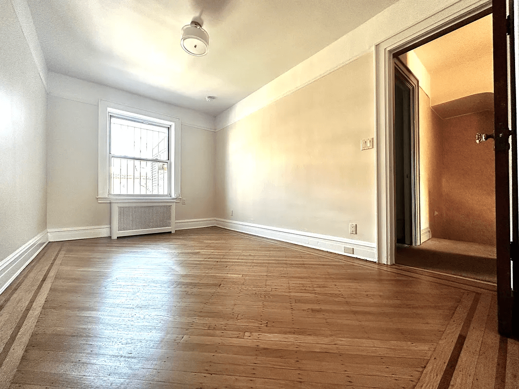 bedroom with wood floor and one window