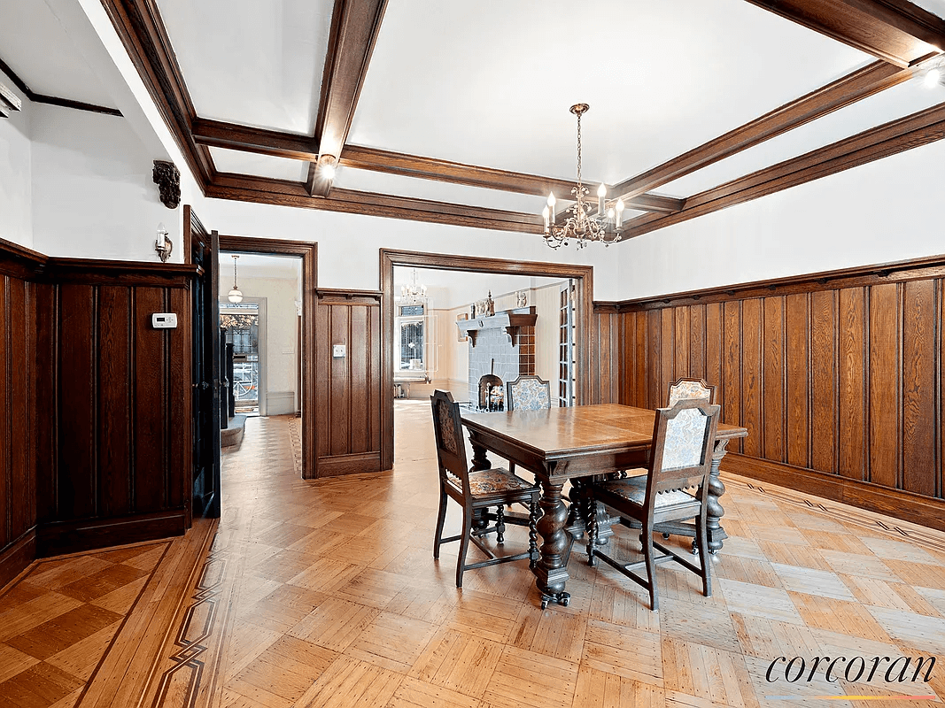 dining room with coffered ceiling and wainscoting