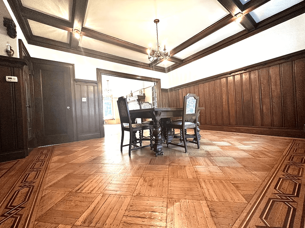 dining room with coffered ceiling and wainscoting