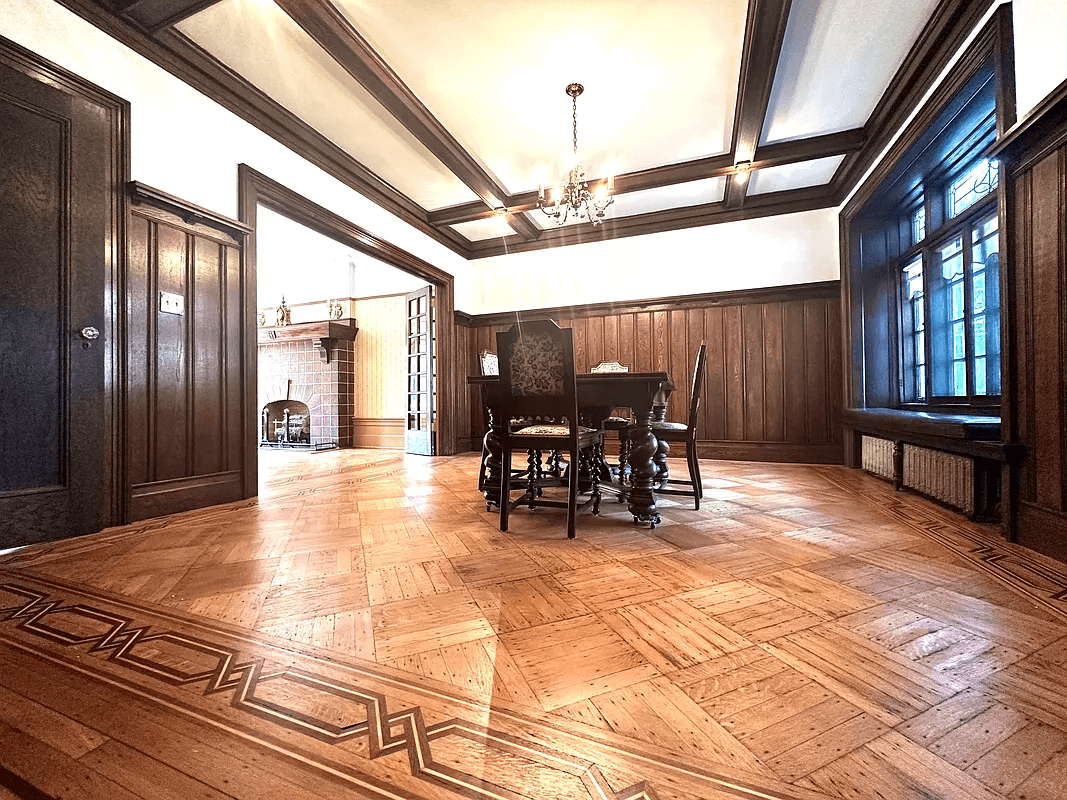 dining room with coffered ceiling and wainscoting