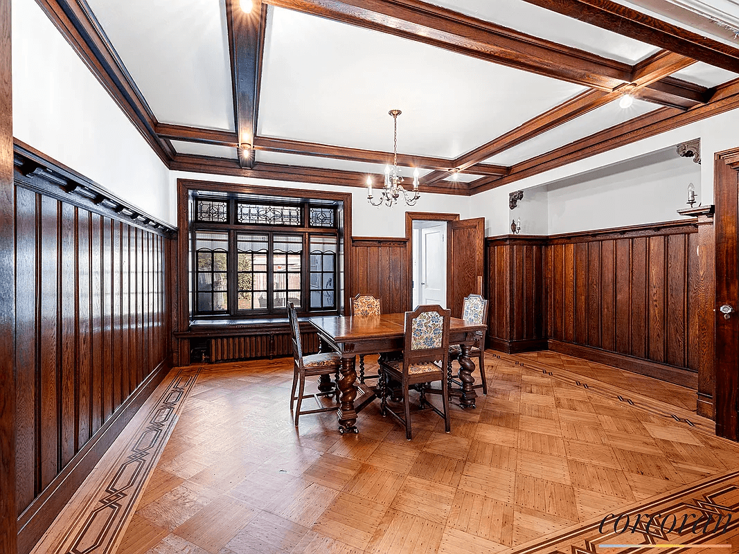 dining room with coffered ceiling and wainscoting