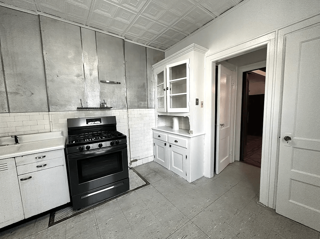 kitchen with tin ceiling and built-in cabinet