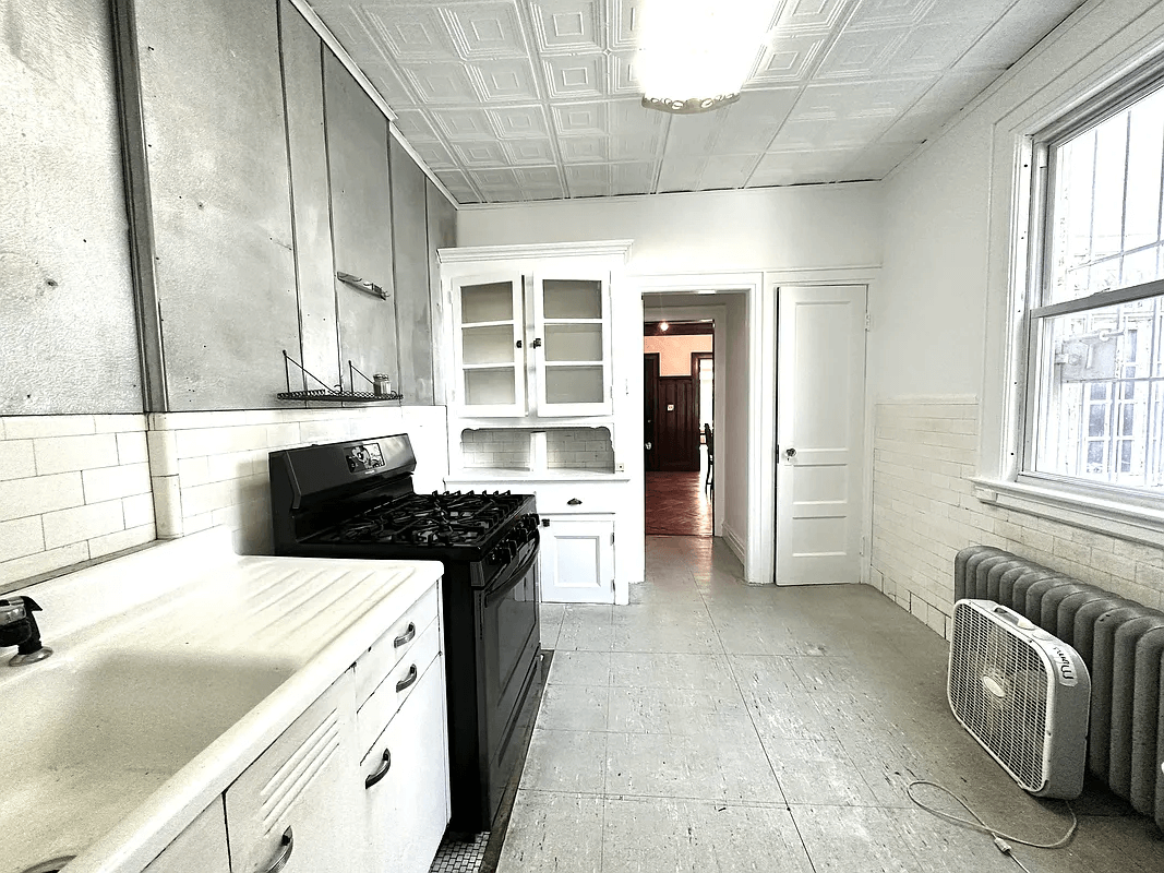 kitchen with tin ceiling and built-in cabinet