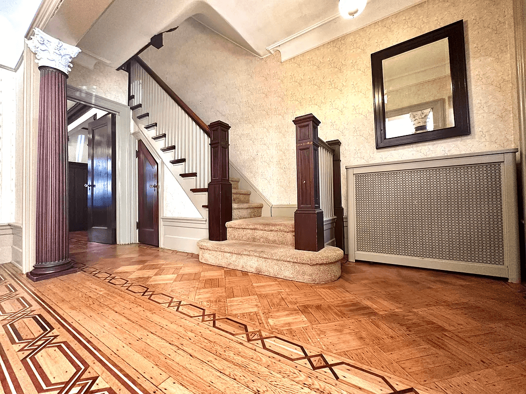 wallpaper and original stair with carpeting in entry hall