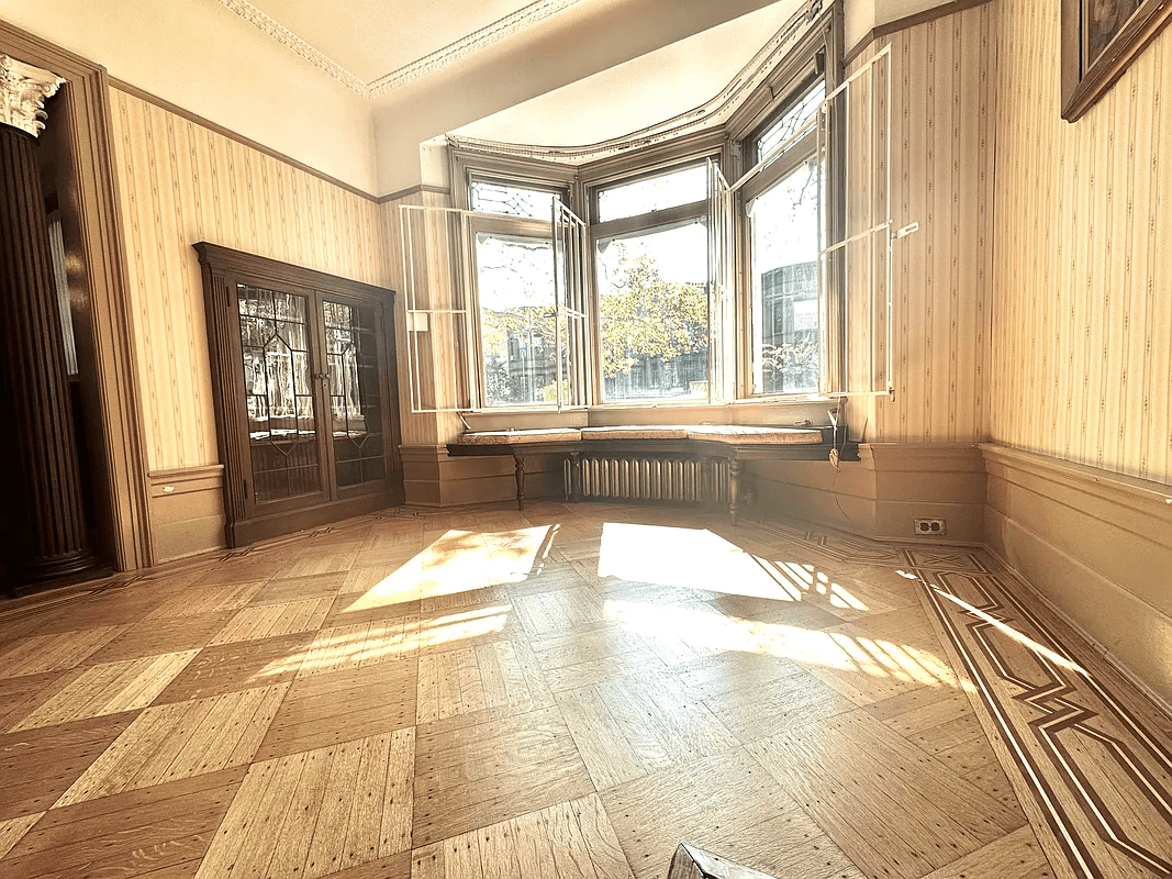 parlor with built-ins and a bay window