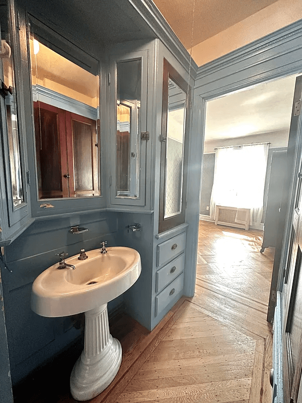 passthrough with blue cabinets and a sink