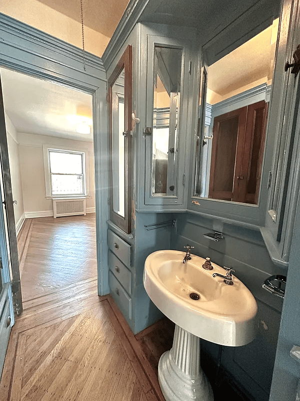 passthrough with blue cabinets and a sink