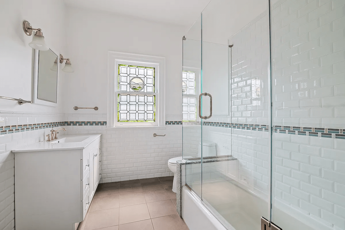 bedroom with stained glass window and white fixtures