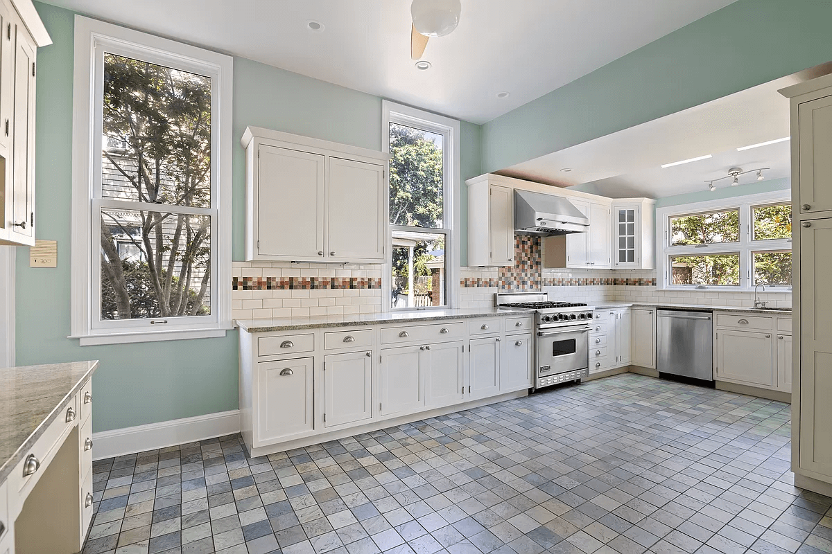 kitchen with white cabinets and multi-colored tile floor and tile backsplash