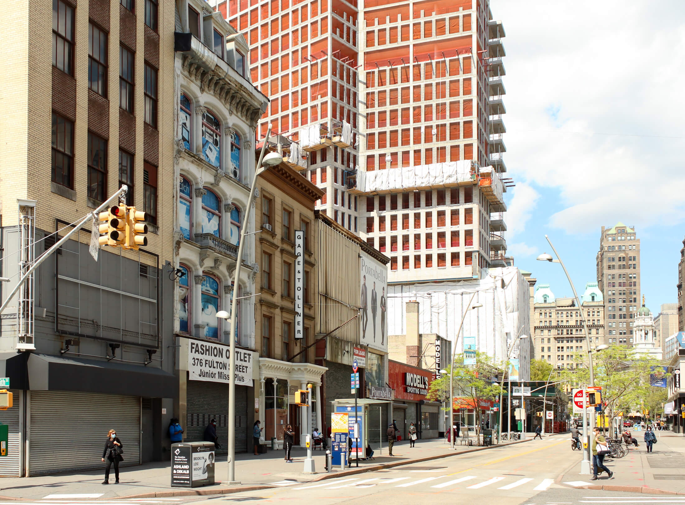 buildings without scaffolding and a sign on gage and tollner