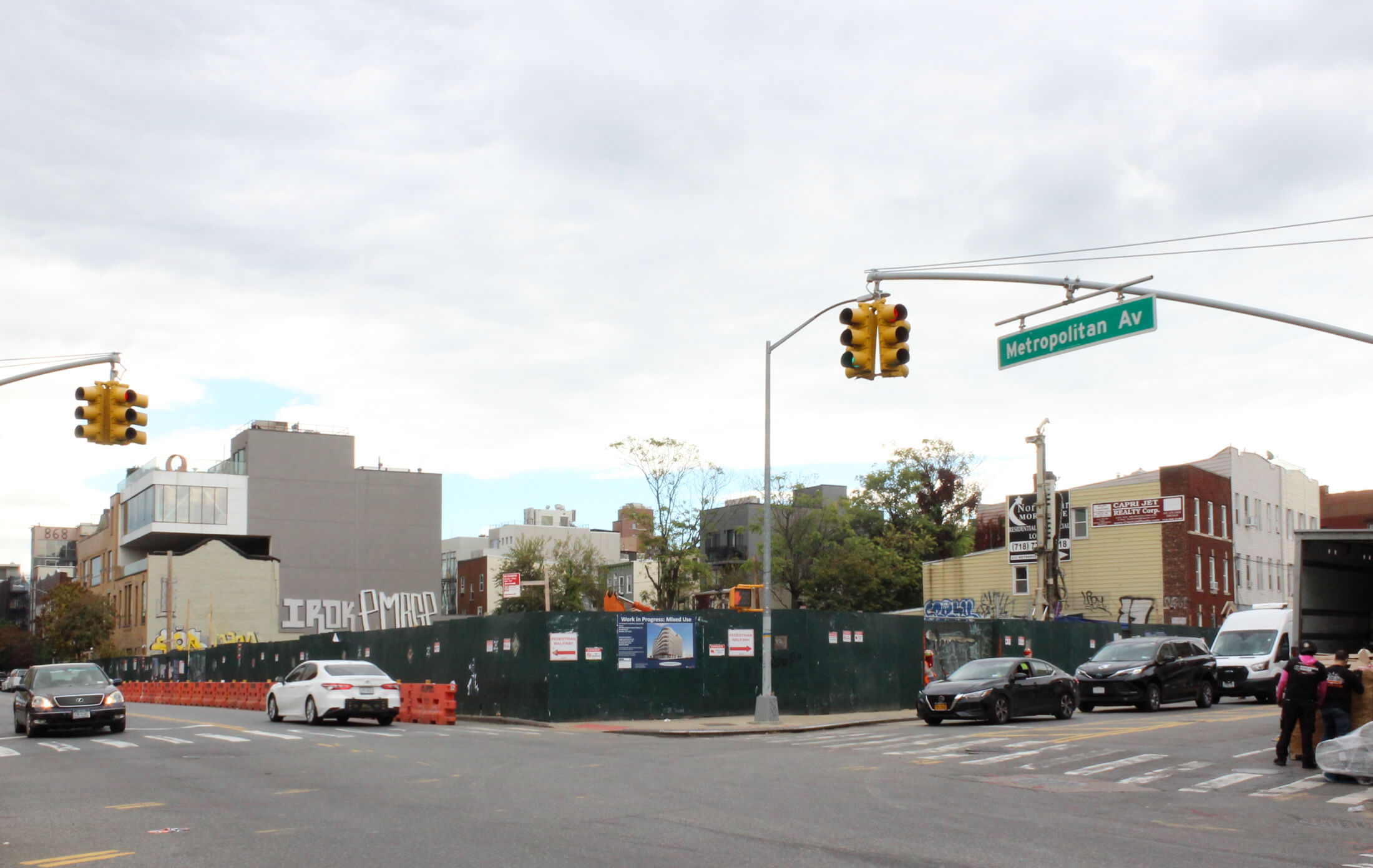 construction fence surround a site on metropolitan avenue