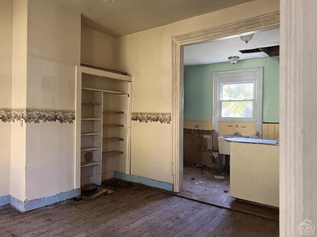 view into kitchen from dining area with wallpaper border