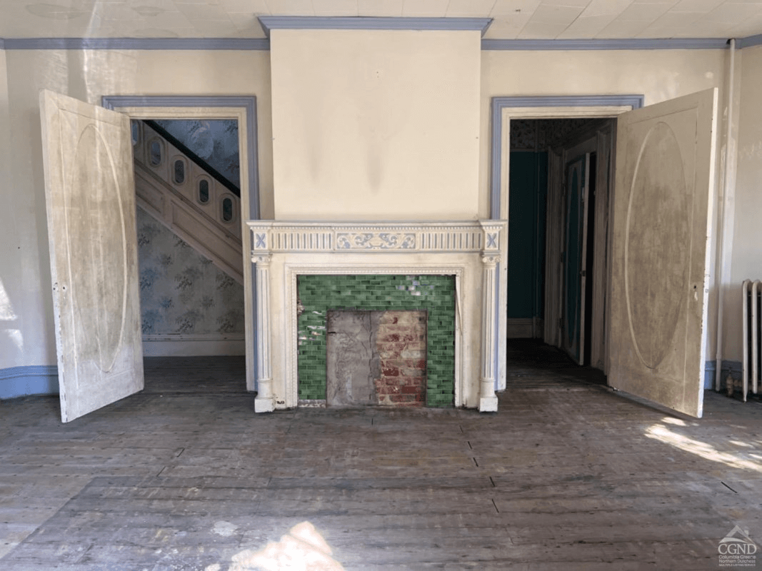 blue and white painted mantel in parlor with green tile