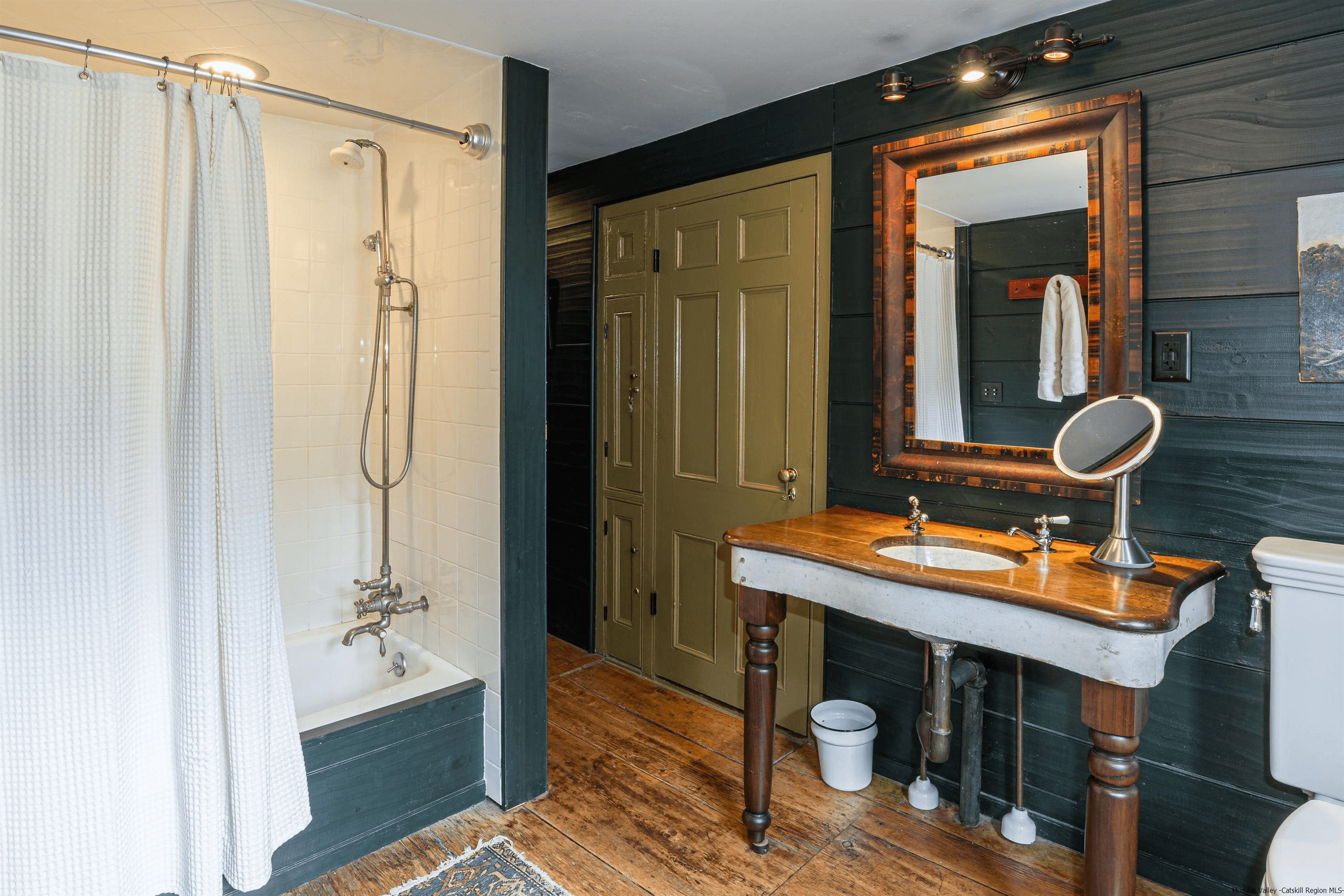 bathroom with a wood encased tub