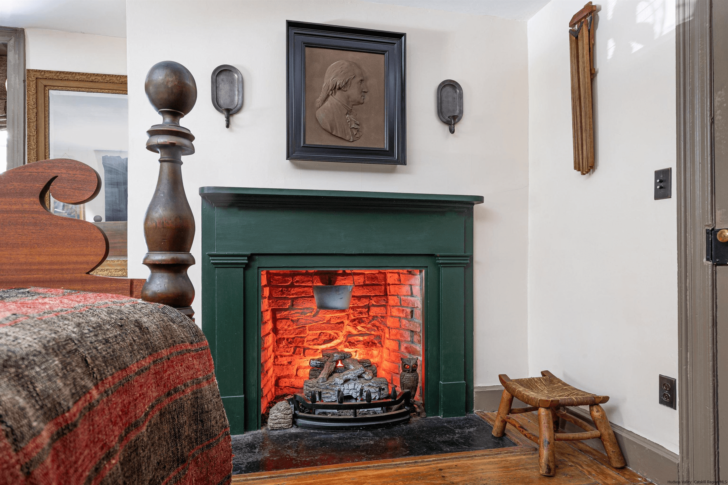 wood mantel painted green in a bedroom