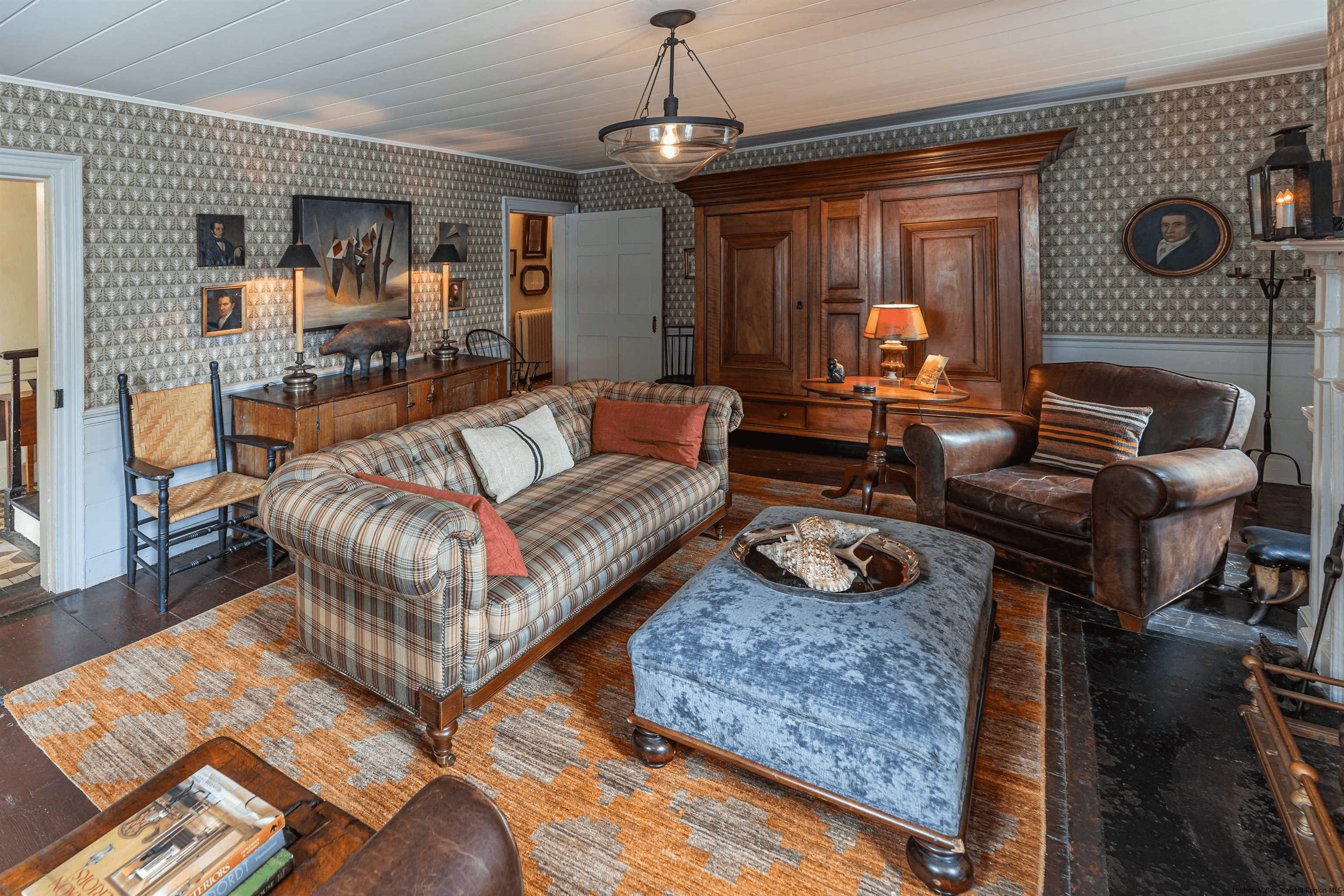 living room with wallpaper above the wainscoting