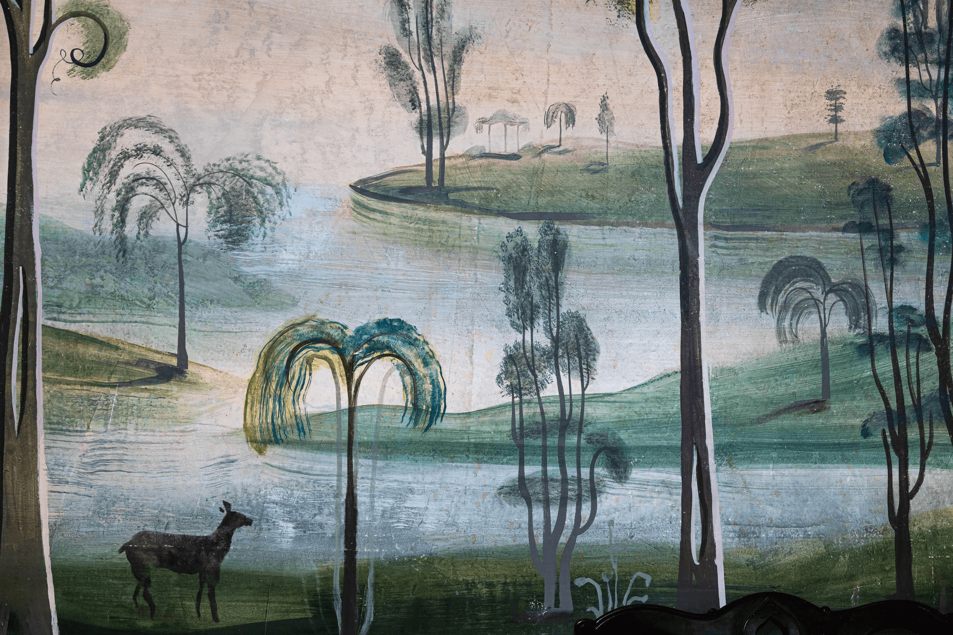 detail of the handpainted mural with trees and a deer