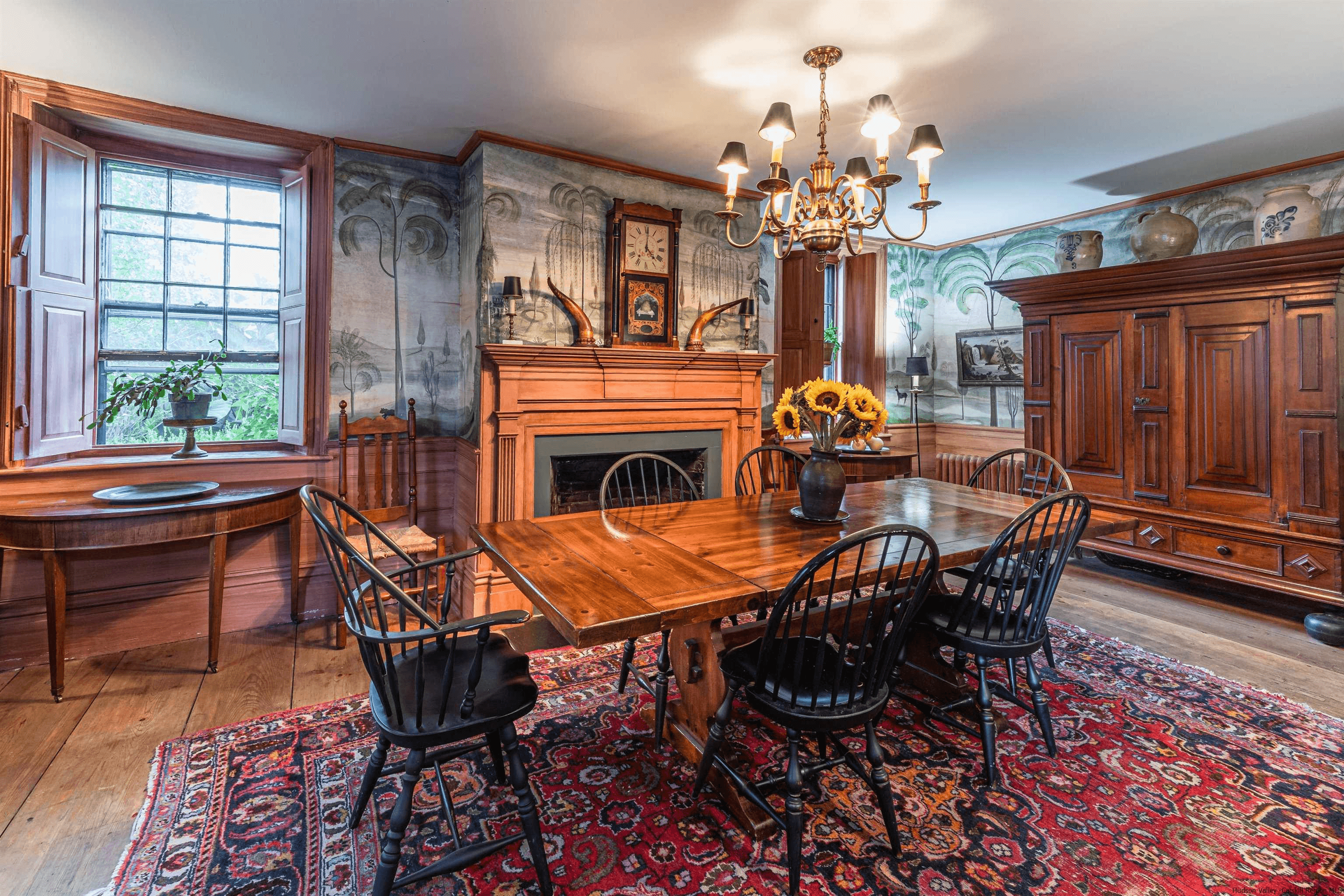 dining room with a wood mantel and a handpainted mural