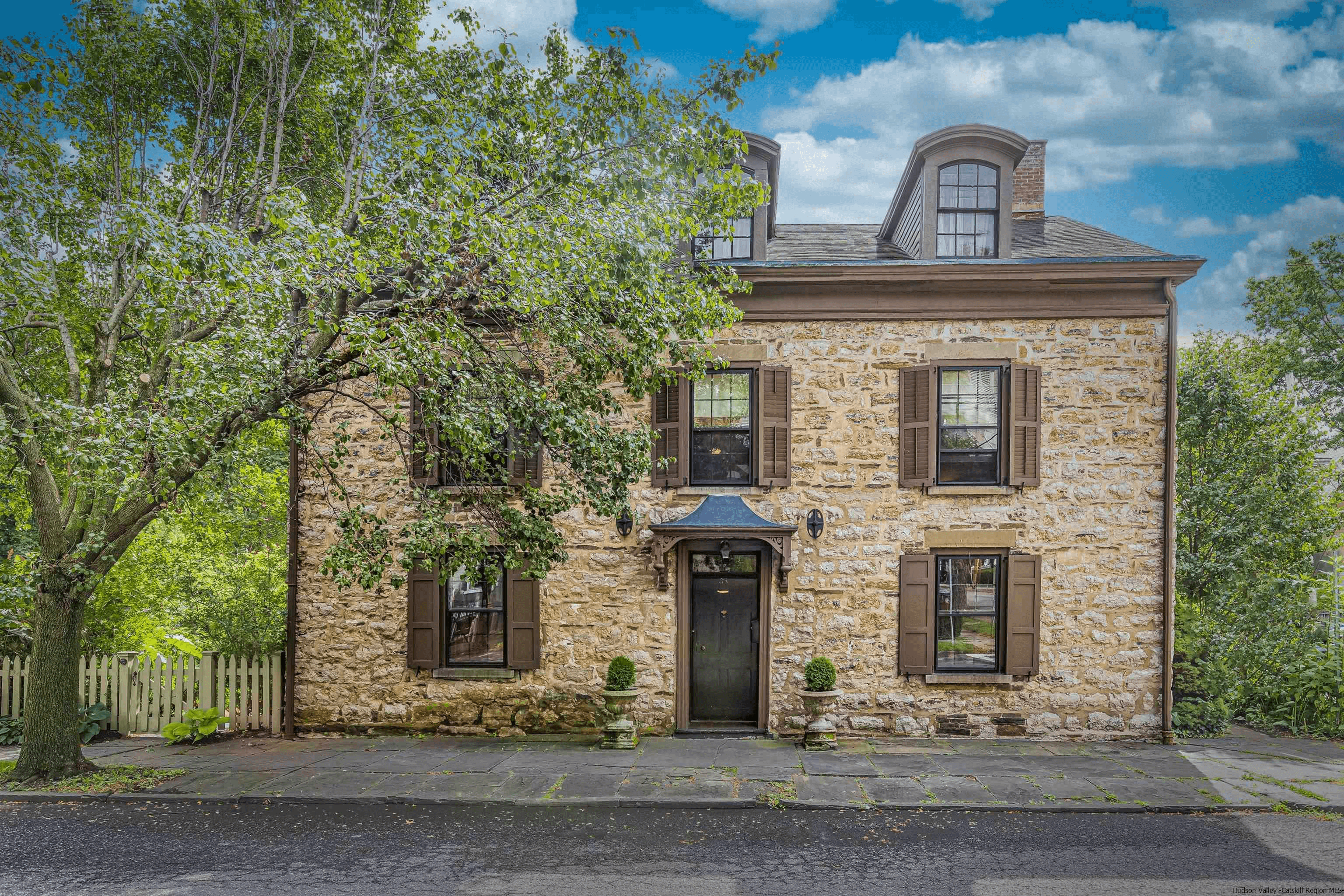 stone exterior of the three bay wide house