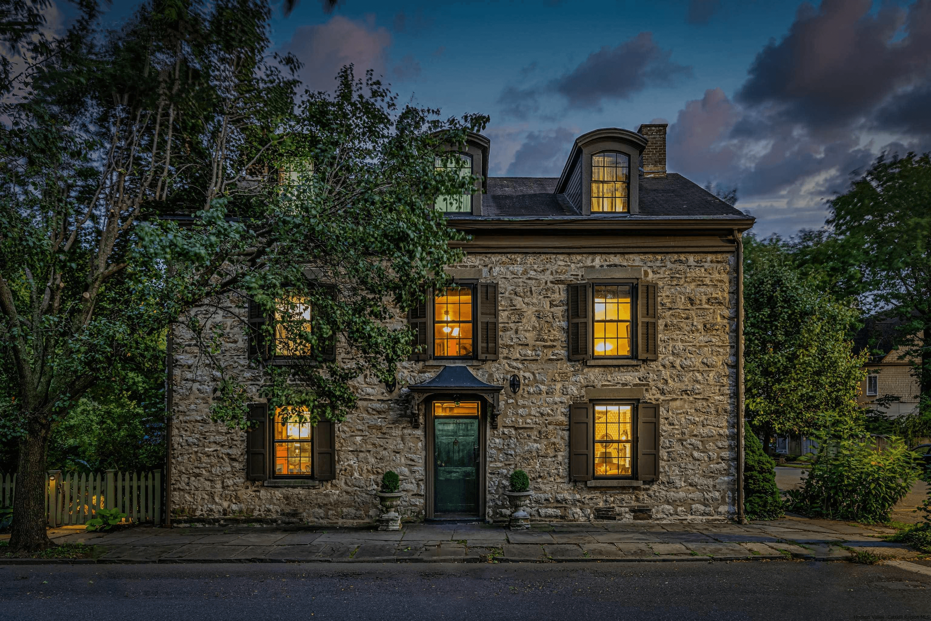 kingston - stone house lit up at night