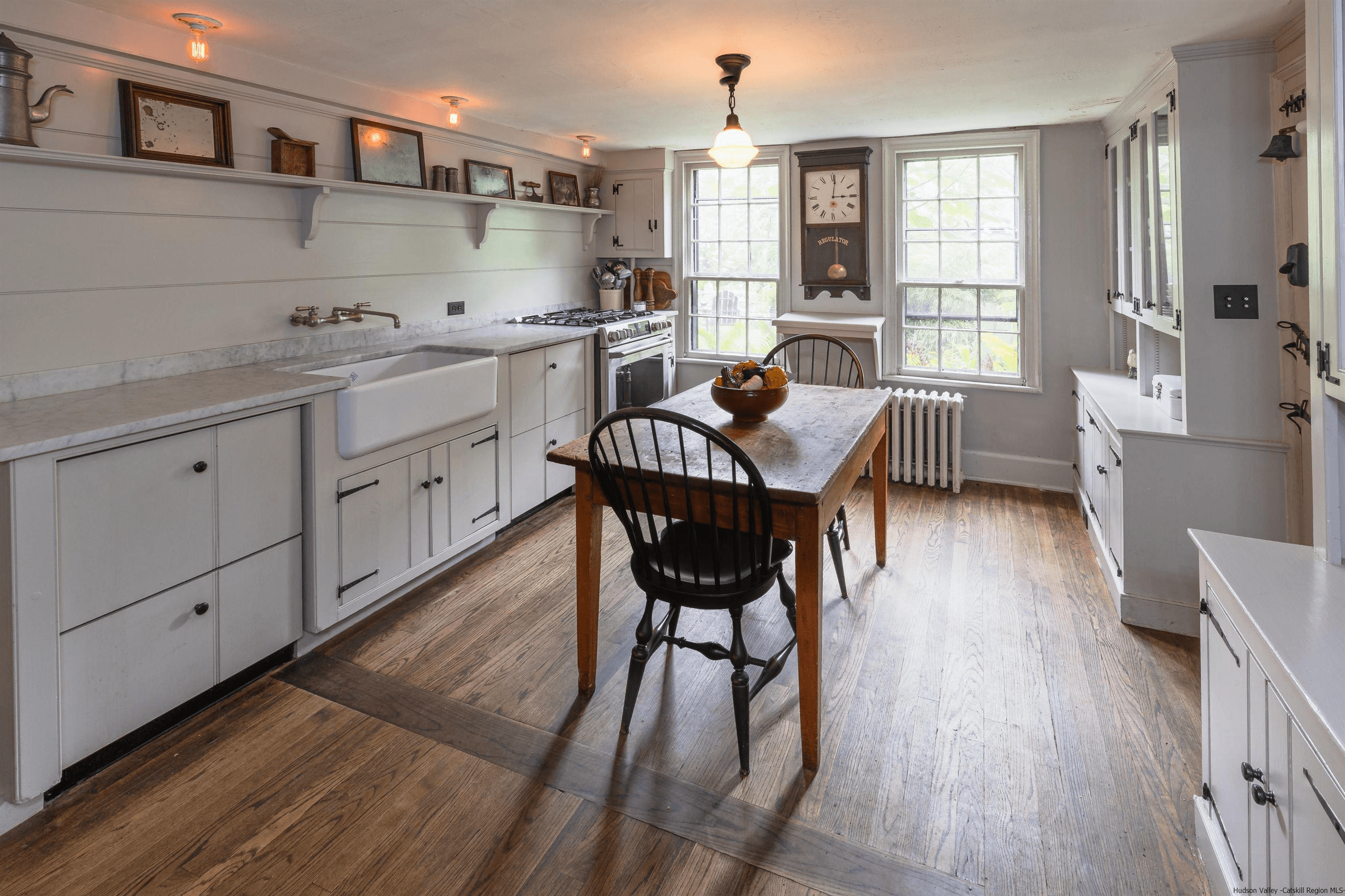 kitchen with apron front sink and open shelving