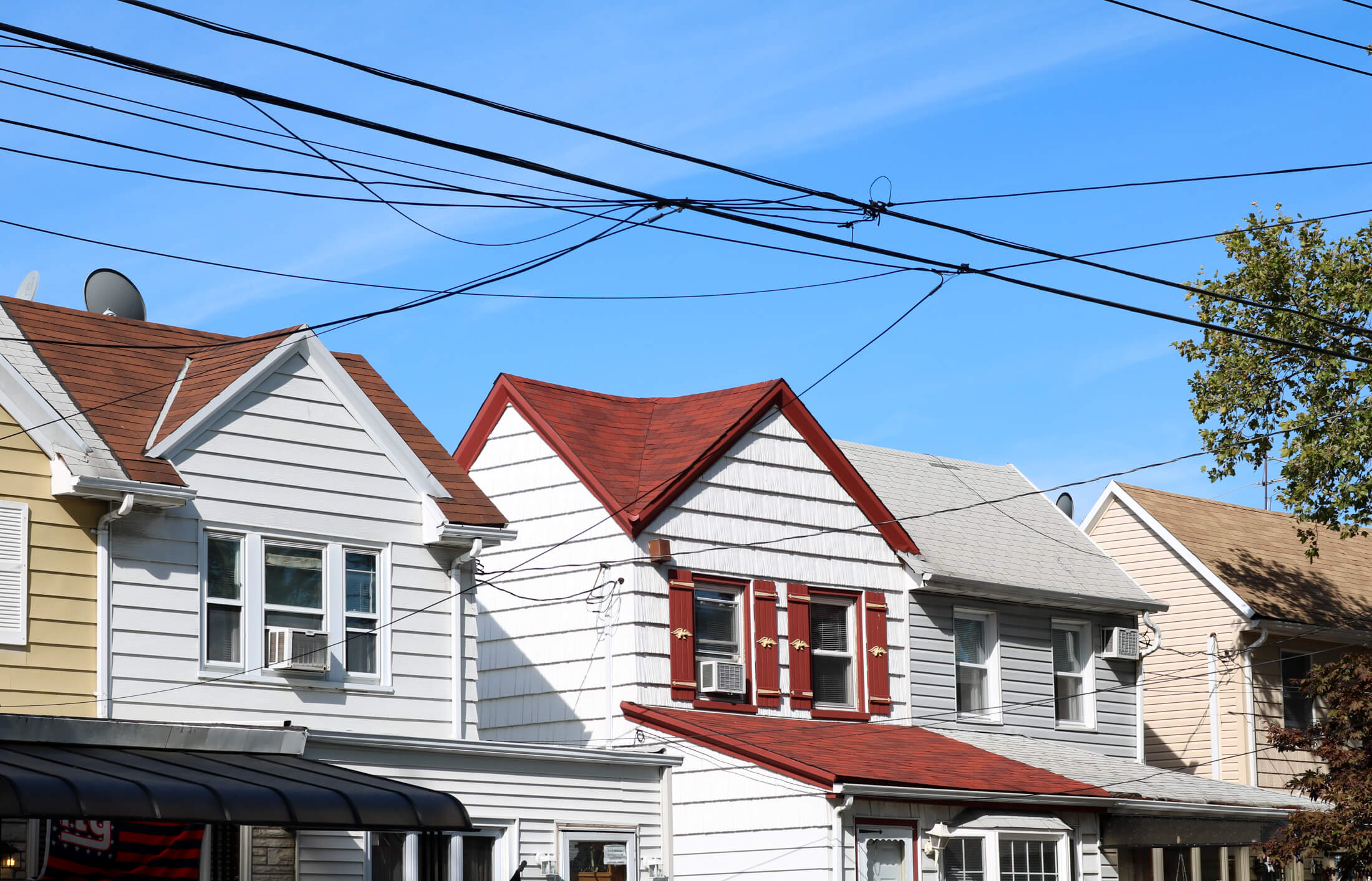 brooklyn - telephone wires in front of vinyl sided houses
