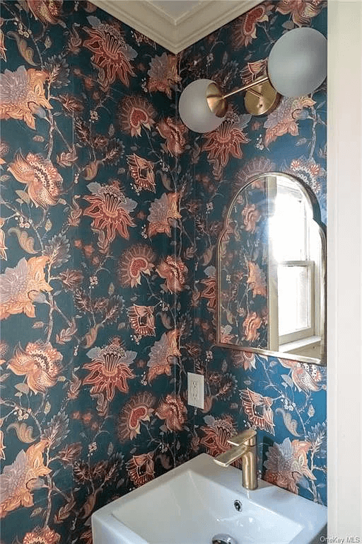 powder room with modern small sink and bold floral wallpaper