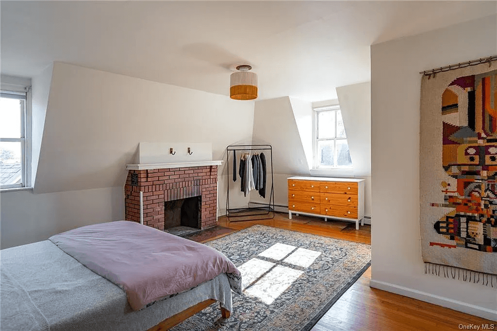 bedroom with brick mantel