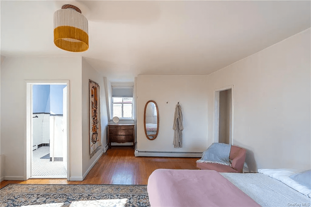 bedroom with baseboard heating and en suite bath