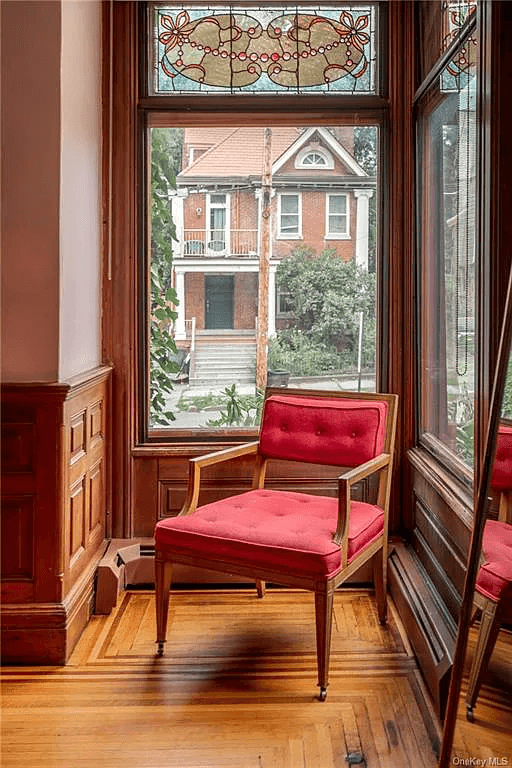 detail of wood floors, wainscoting and stained glass window