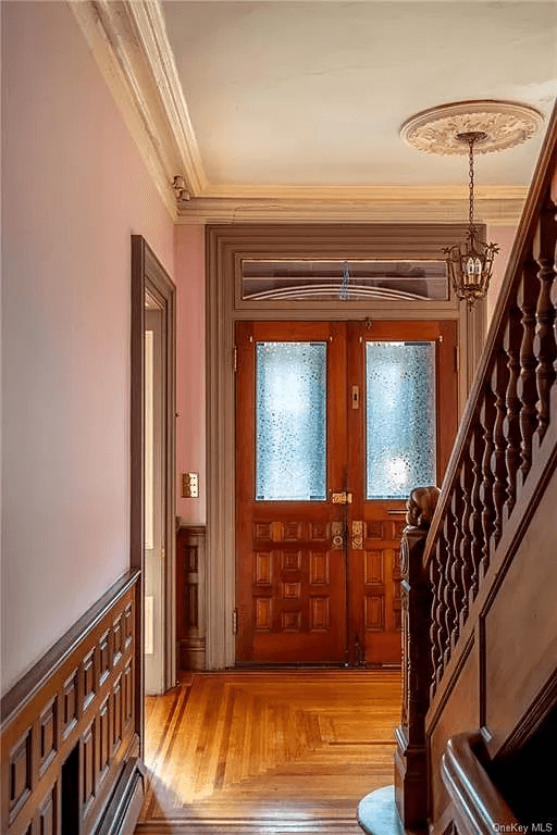 original double entry doors and a view of the hall ceiling medallion