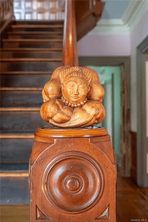modern carving on top of the newel post