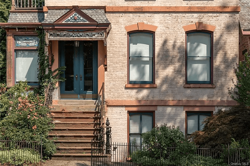 detail of first level exterior with pale painted brick exterior
