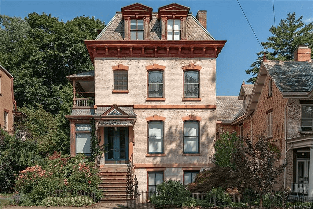 newburgh- pale brick exterior of house with mansard roof
