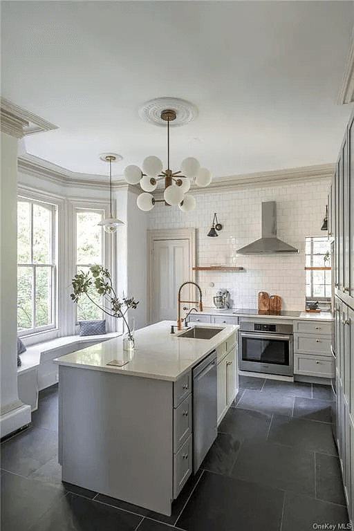 renovated kitchen with stone floors and large island