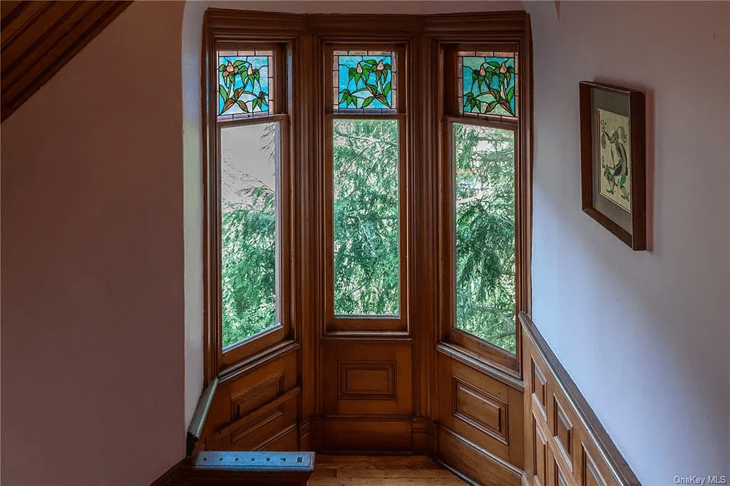 bay window on stair landing with stained glass windows