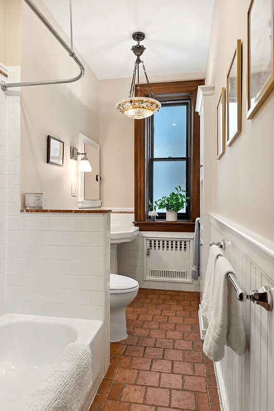 windowed bathroom with white fixtures