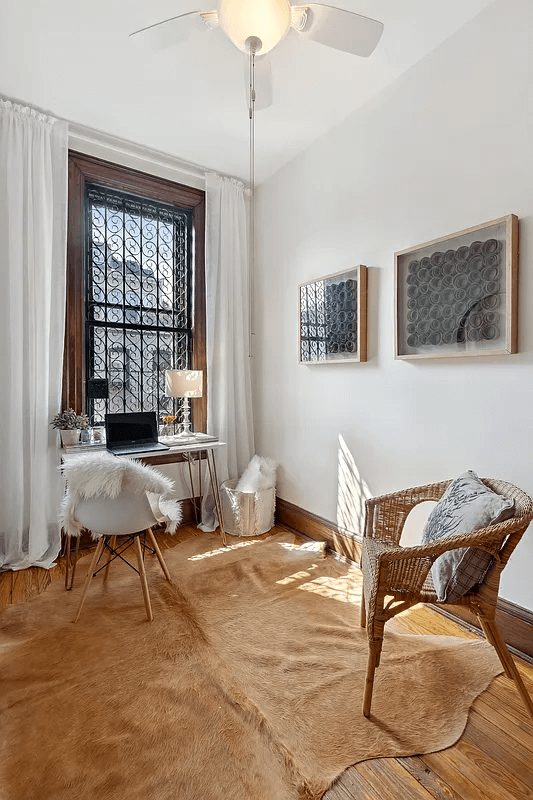 bedroom with wood floors and a ceiling fan