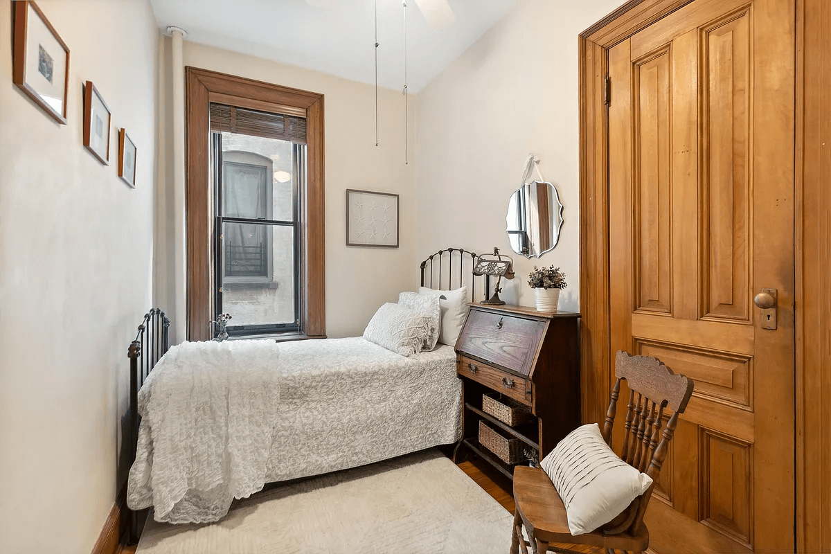 narrow bedroom with wood floor