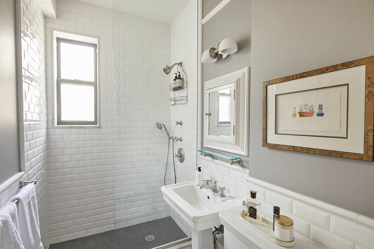 bathroom with shower and white fixtures