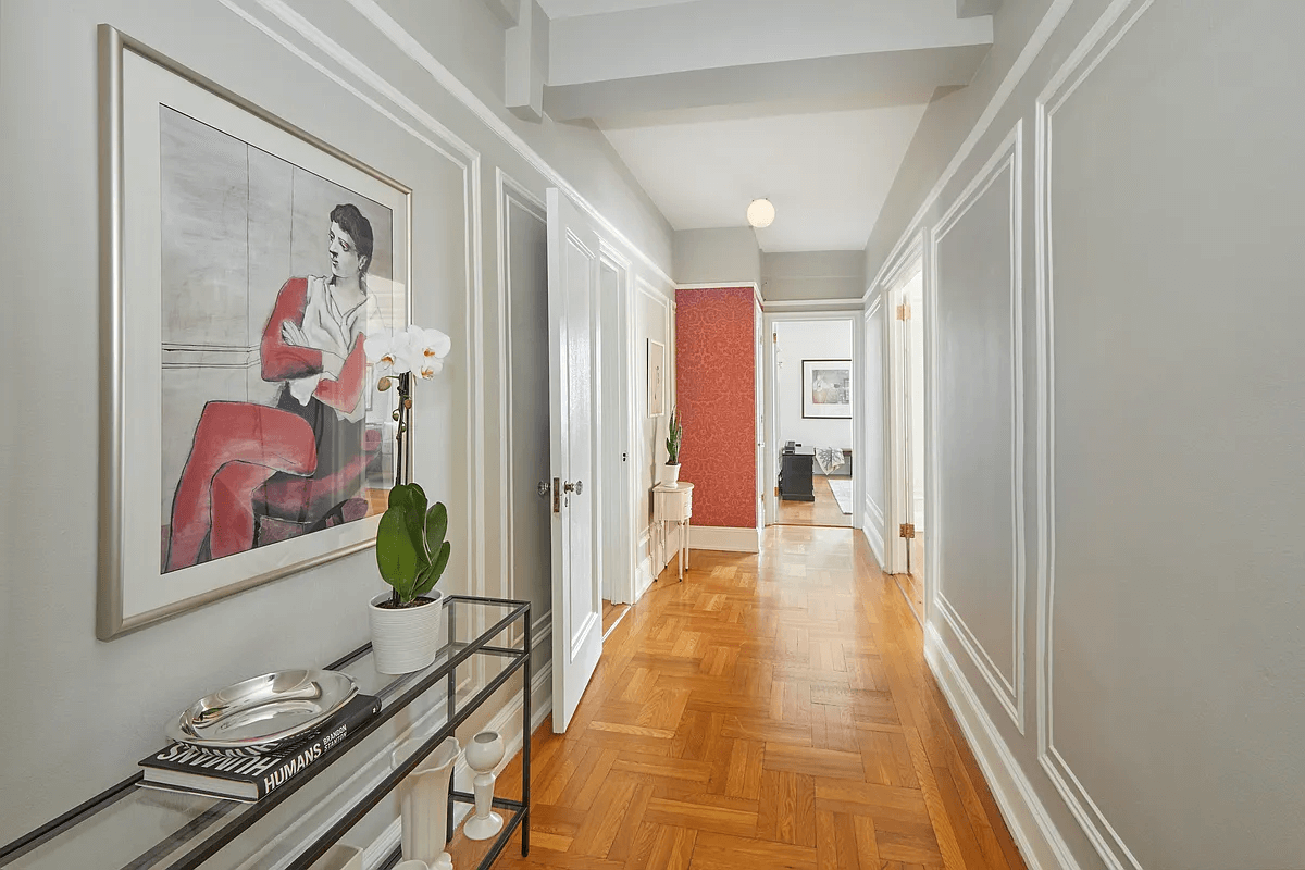 wide hallway with wall moldings and wood floor
