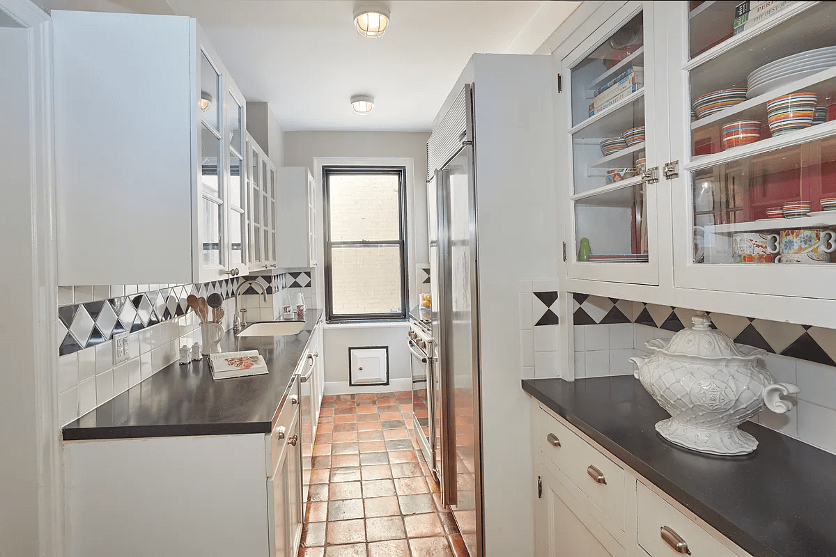 kitchen with white cabinets and terra cotta tile floor