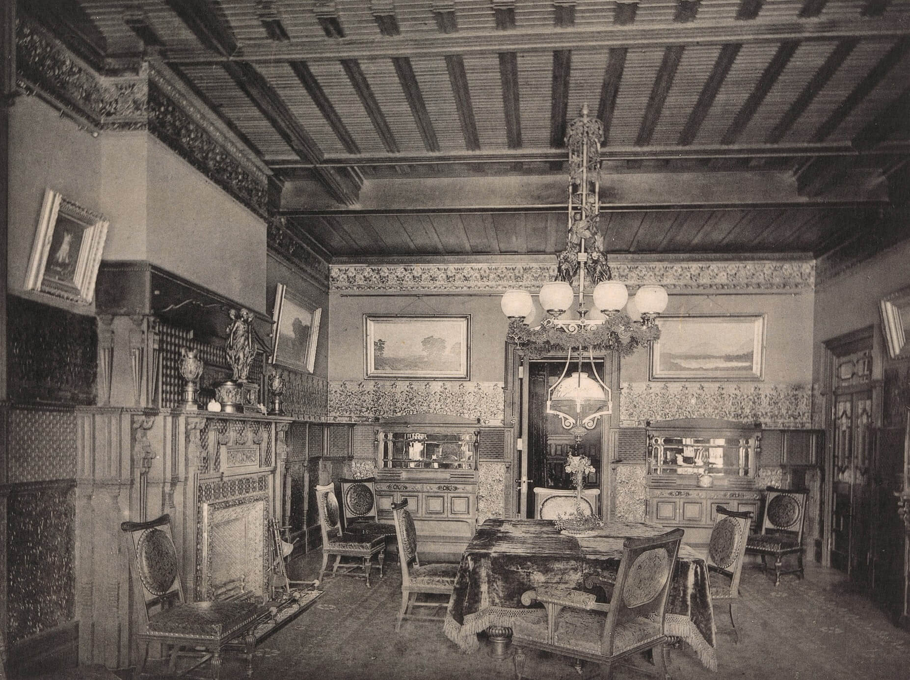 black and white image of a lavish dining room with built-ins