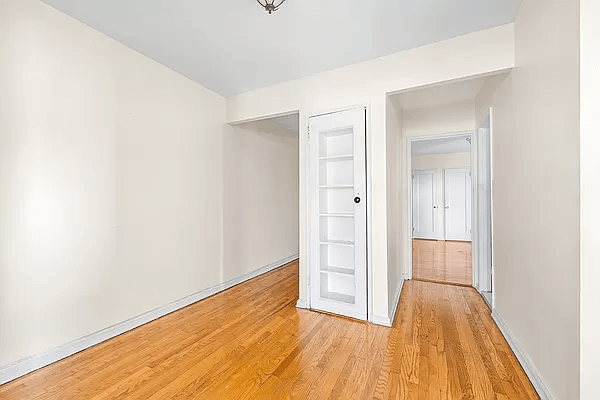 foyer with a niche with shelves and a glass door