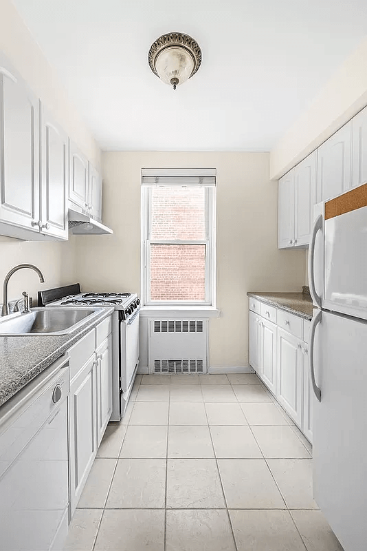 kitchen with white cabinets and a window