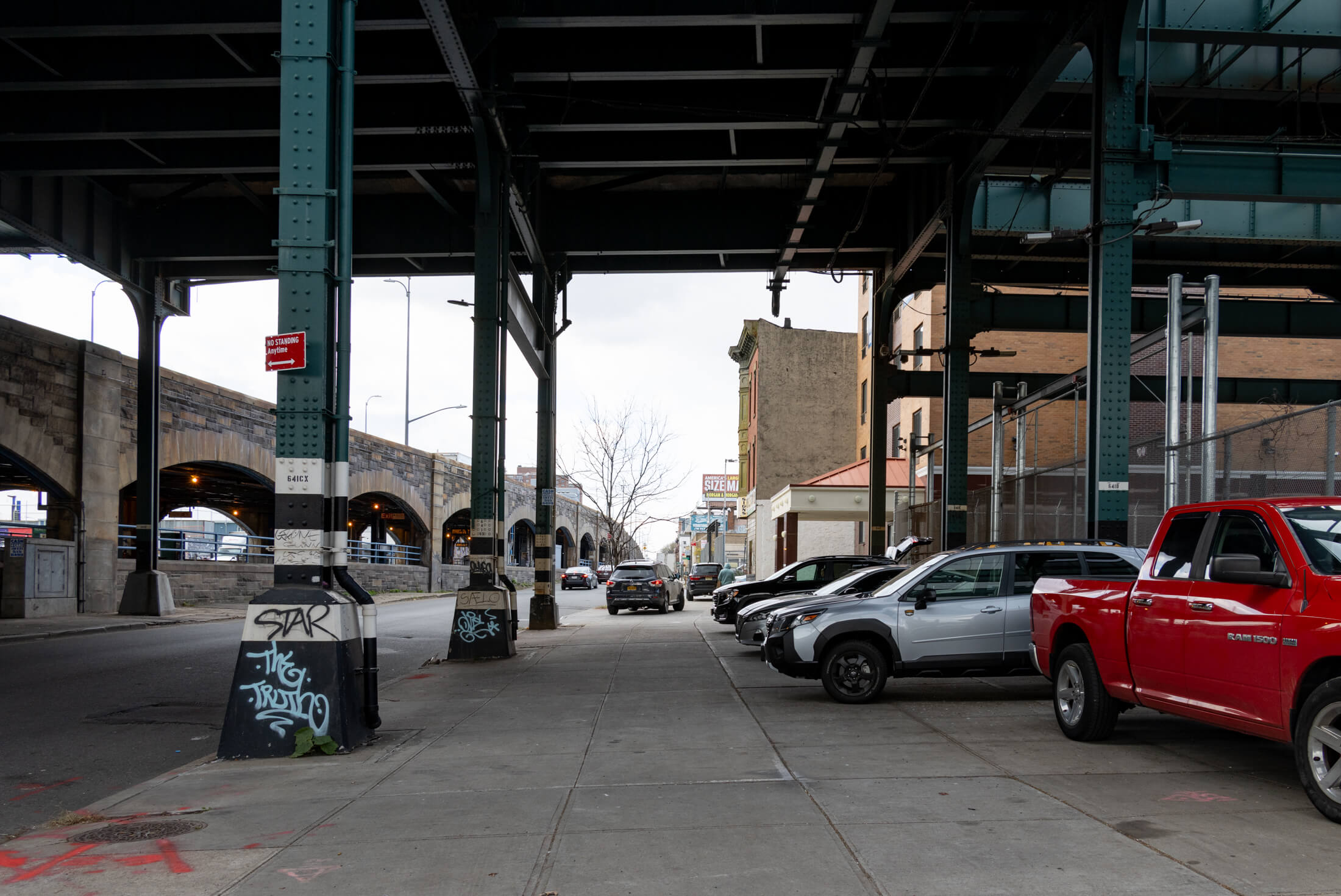 underneath the elevated tracks with a view of buildings